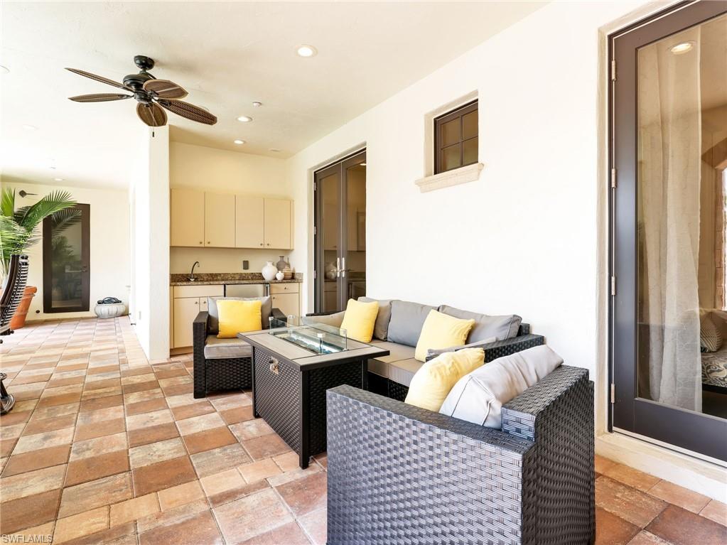 Outside Sitting area with a fire pit featuring a wet bar