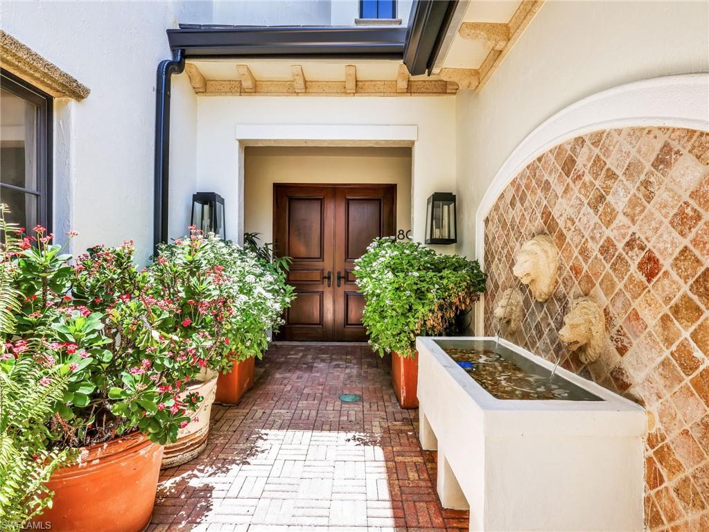 Private entry w/ water feature and lush landscape