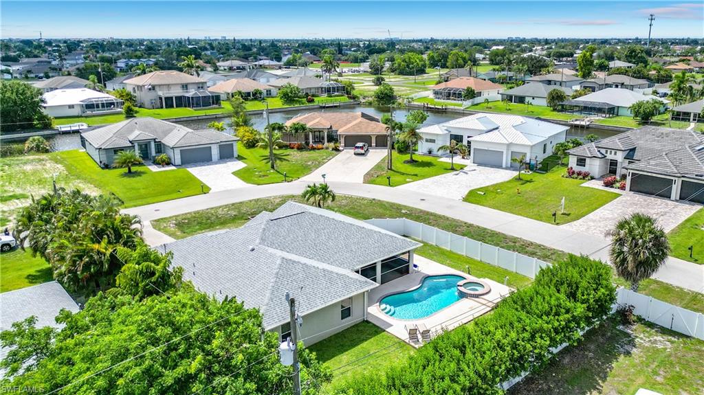 Aerial property view featuring a private swimming pool with integrated spa