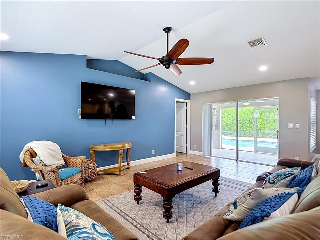 Vaulted ceilings with recessed lighting and a ceiling fan
