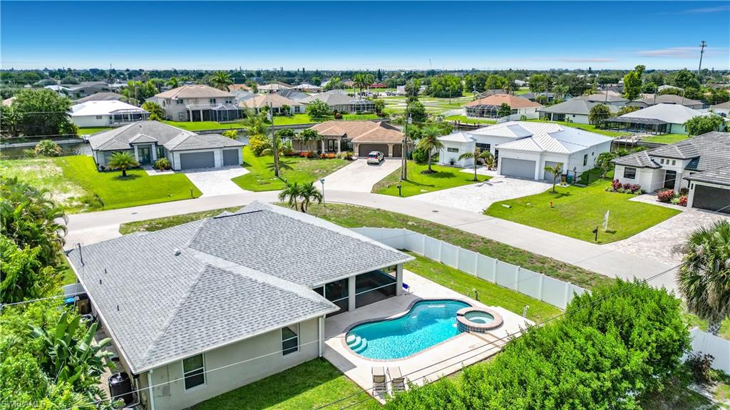 Single-story residence featuring swimming pool with an integrated spa, surrounded by a paved patio