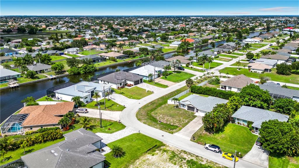 Aerial perspective showcasing a residential neighborhood with canal access