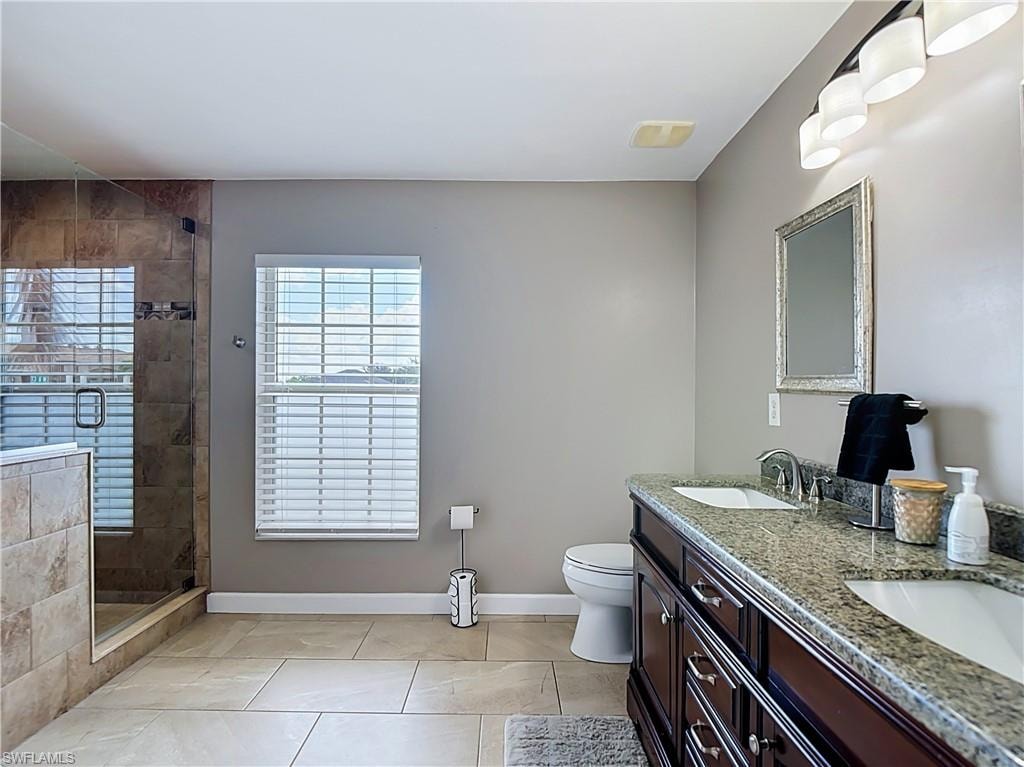 Large master bathroom with walk in closet and dual sinks