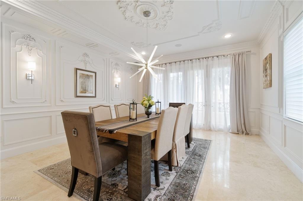 Formal dining room with incredible moldings on ceiling as well as walls, opens up to your private balcony.