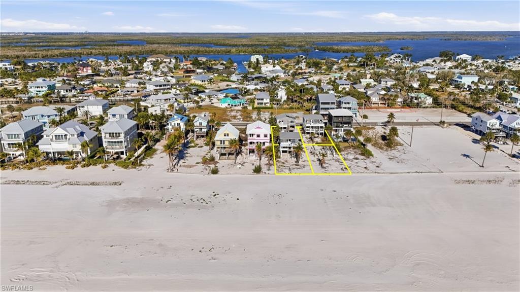 Expansive sandy beach with waterfront properties