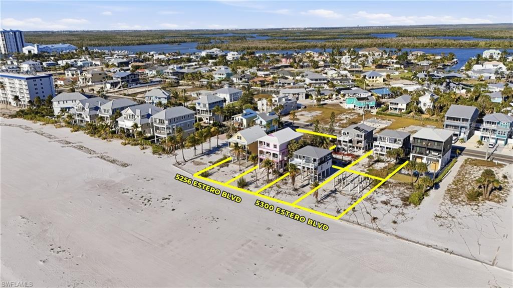 Beachfront land parcels featuring direct sand access and surrounding residential properties