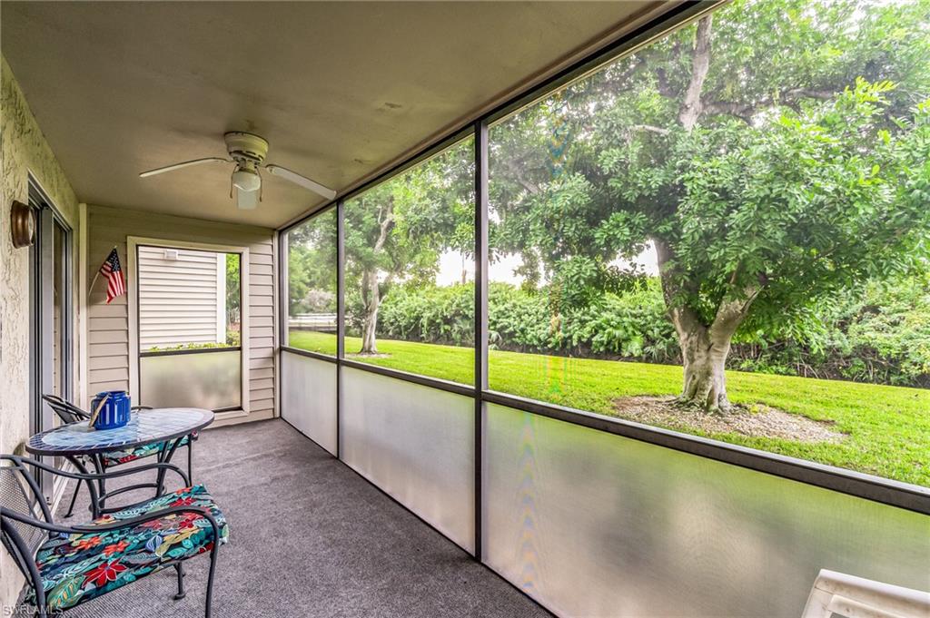 Screened porch with textured ceiling and a ceiling fan