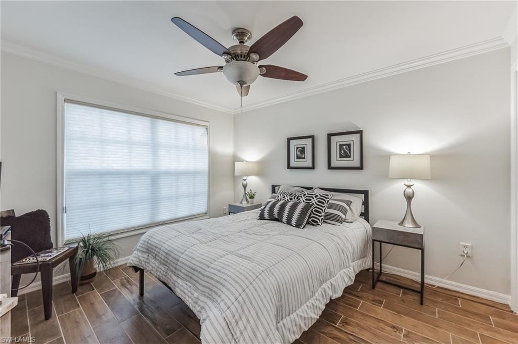 Spacious room featuring wood-finish tile flooring and crown molding