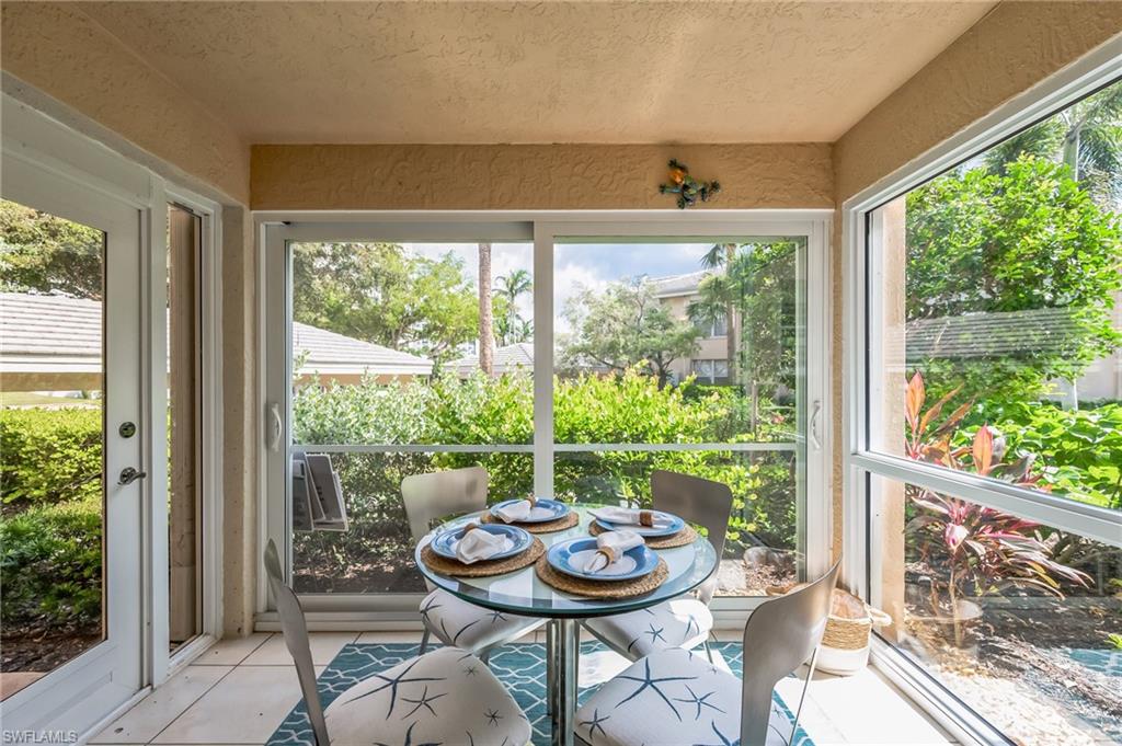 Screened outdoor patio featuring light-toned tile flooring and textured walls