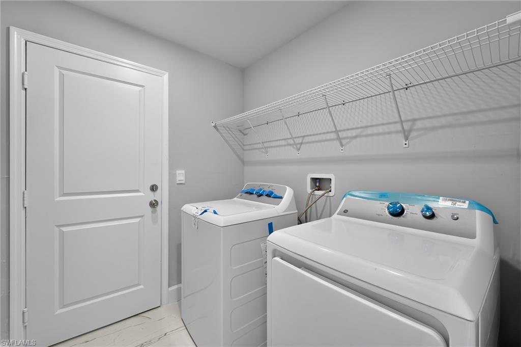 Dedicated laundry area with light gray wall paint