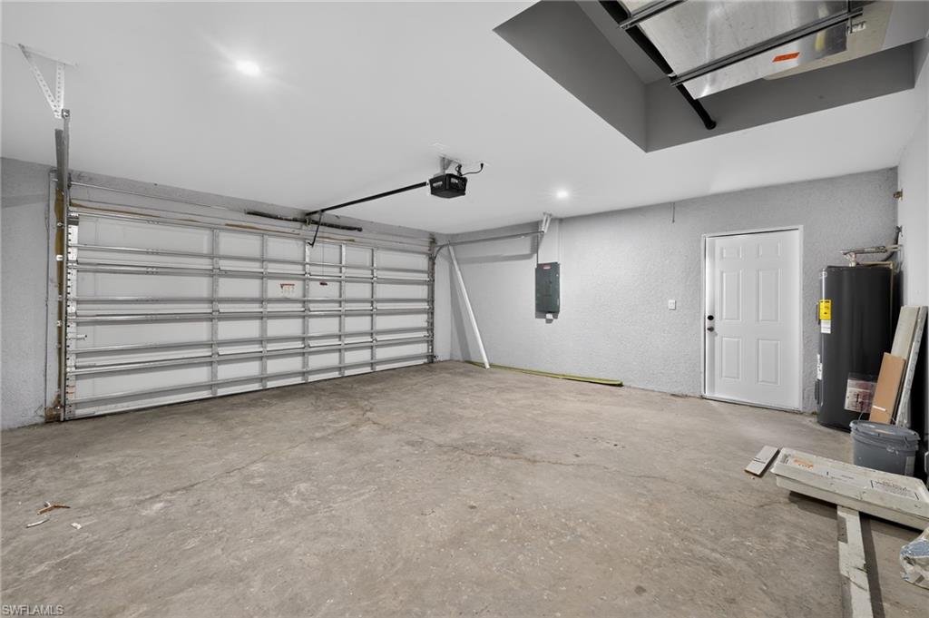 Attached garage with a roll-up door and automatic opener