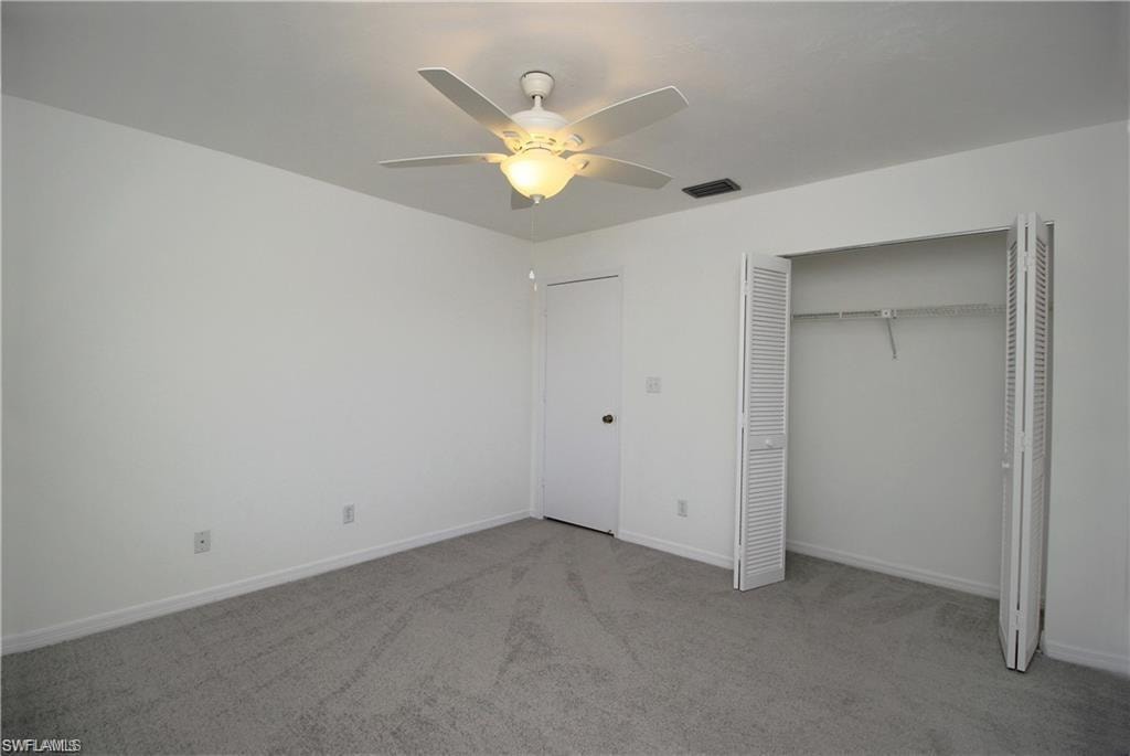 Unfurnished bedroom featuring a closet, ceiling fan, and carpet floors