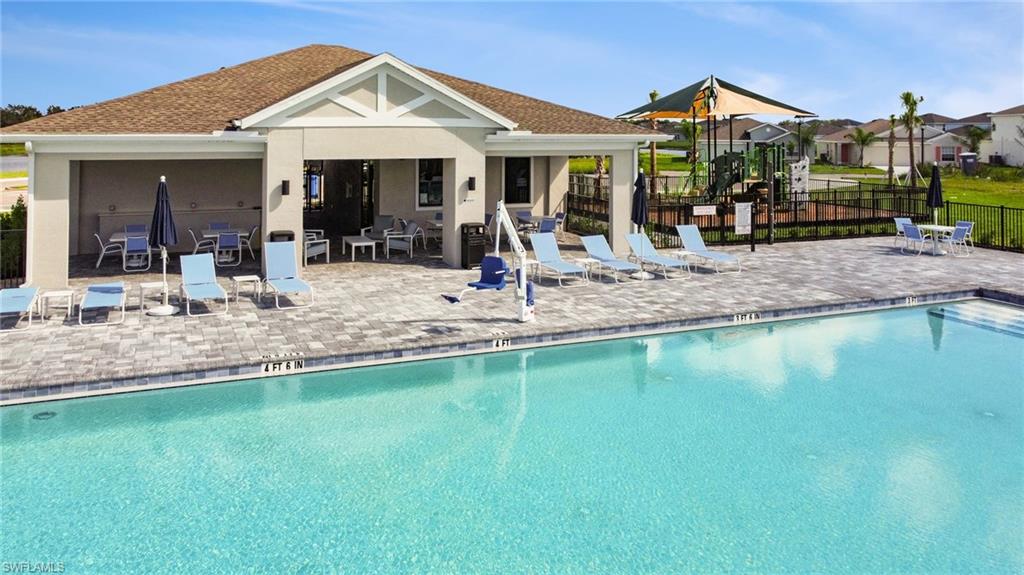 Resort-style swimming pool featuring integrated steps and a spacious surrounding paver deck
