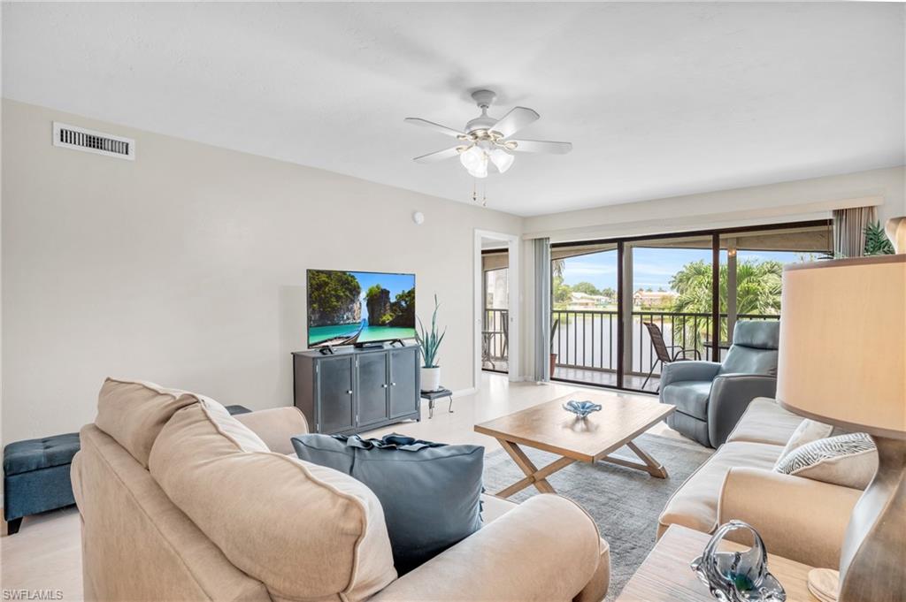 Living room featuring ceiling fan and light hardwood / wood-style floors