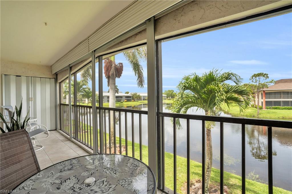 Sunroom / solarium with a water view