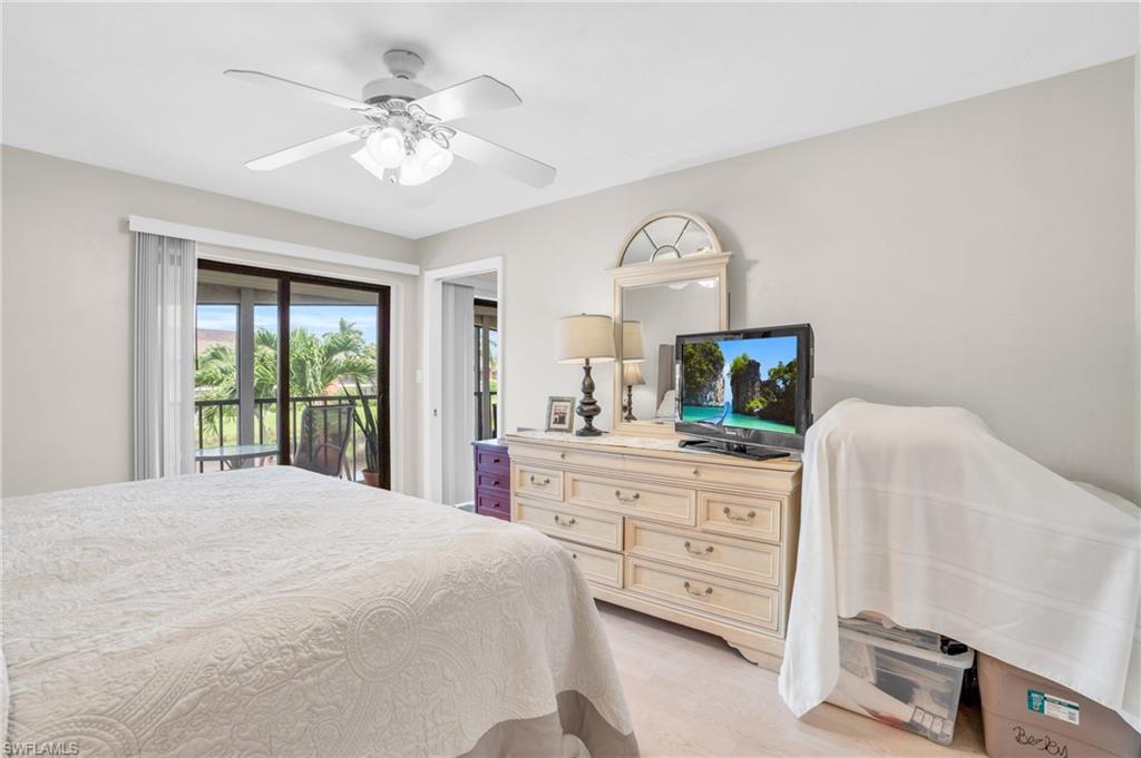 Bedroom featuring access to outside, light wood-type flooring, and ceiling fan