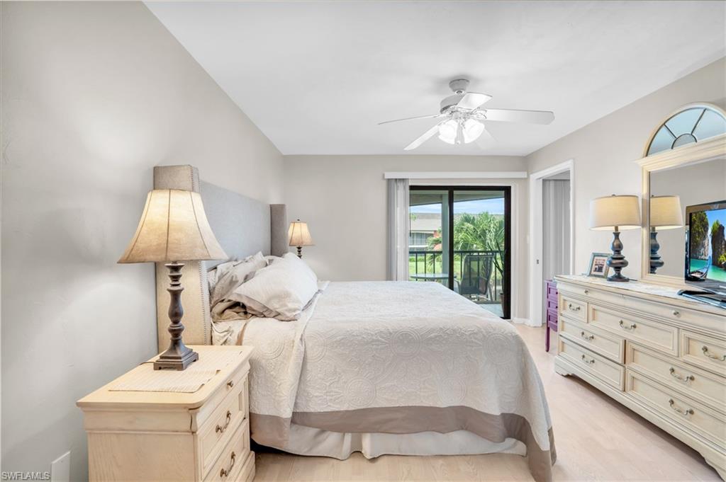 Bedroom with light hardwood / wood-style floors, access to exterior, and ceiling fan