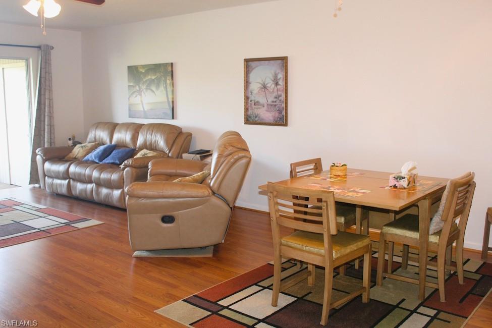 Living area with wood finished floors and ceiling fan