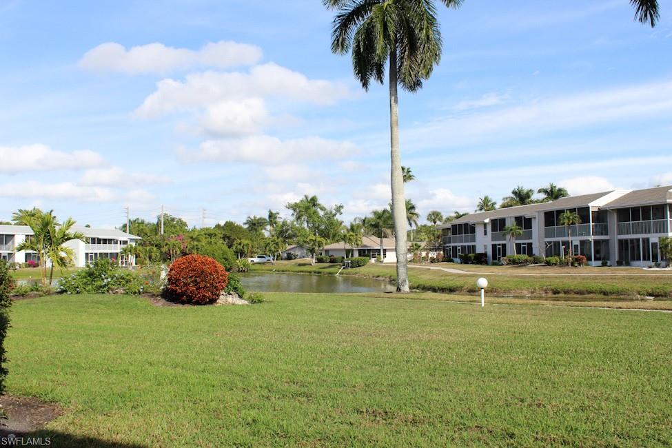 View of grassy yard with a water view