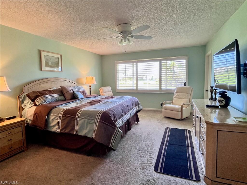 King size bed with golf course views and large dresser.