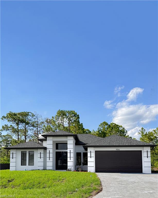 Contemporary exterior with white stucco finish and dark trim accents