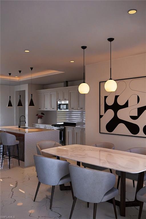 Open-concept living space featuring a dining area with a marble-finish tabletop and stylish seating