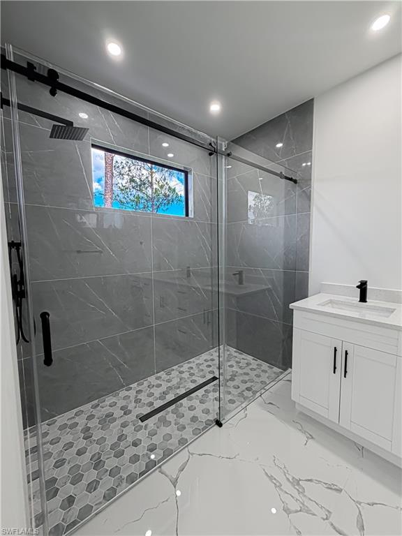 Contemporary bathroom featuring a spacious glass-enclosed shower with matte black hardware