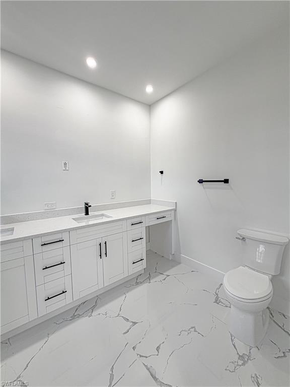 Modern bathroom featuring a white vanity with black hardware, an undermount sink, and a quartz countertop