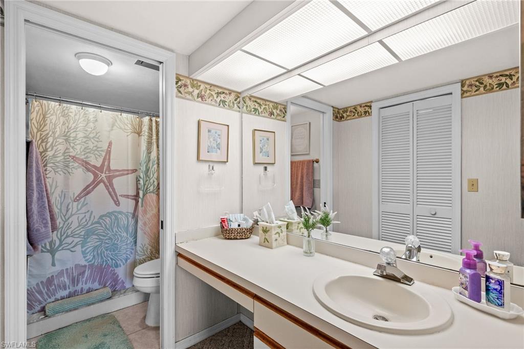 Bathroom vanity with an integrated sink and a large wall-mounted mirror