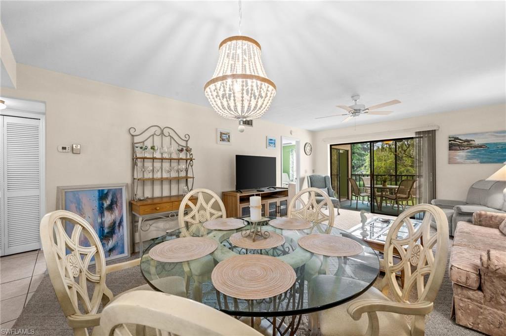 Spacious interior featuring a beaded chandelier, light-toned walls, and a ceiling fan