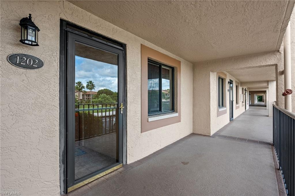 Arrive on the second floor walkway at Unit 1202, with a golf course view at your door.