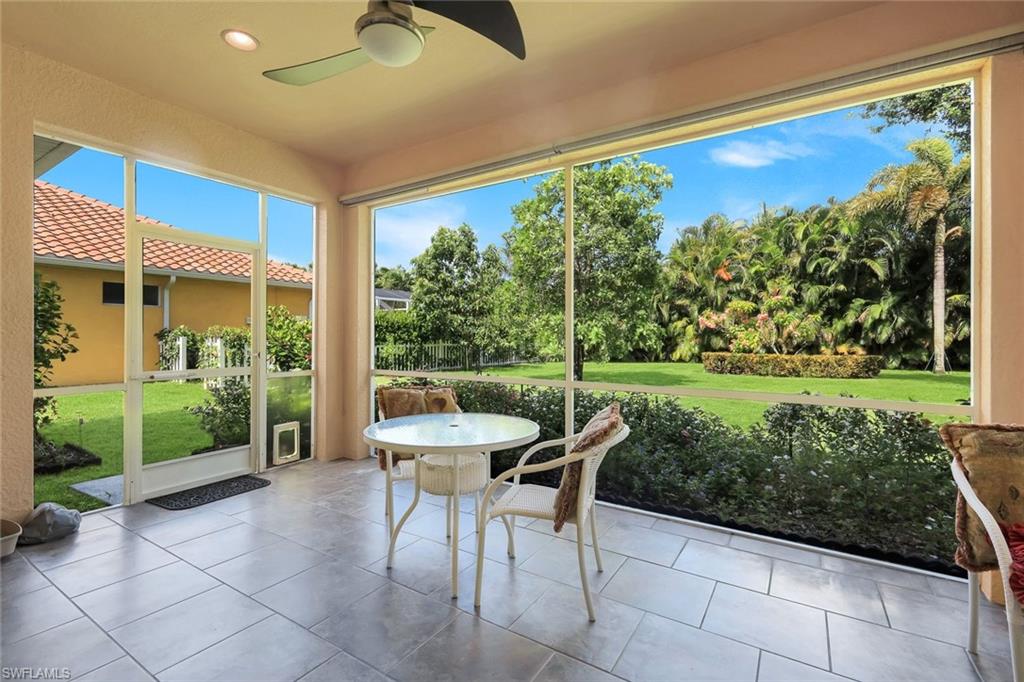 Screened outdoor living area featuring large format tile flooring and a ceiling fan