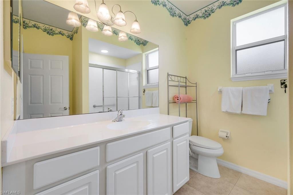 White vanity with integrated sink and chrome faucet