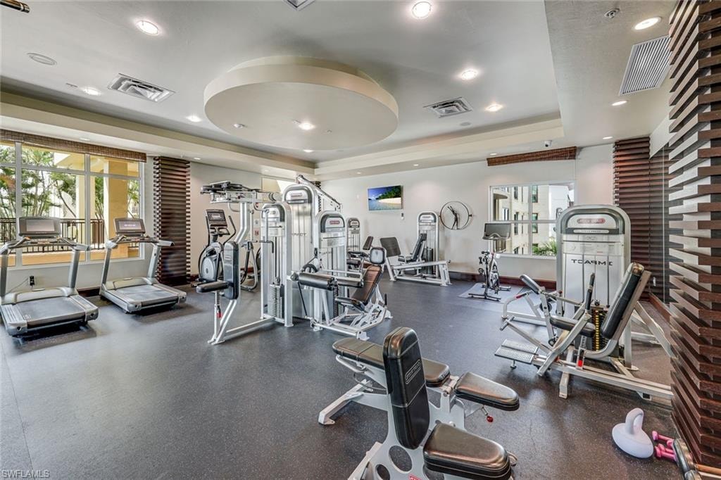 Fitness center featuring a rubberized floor and recessed lighting