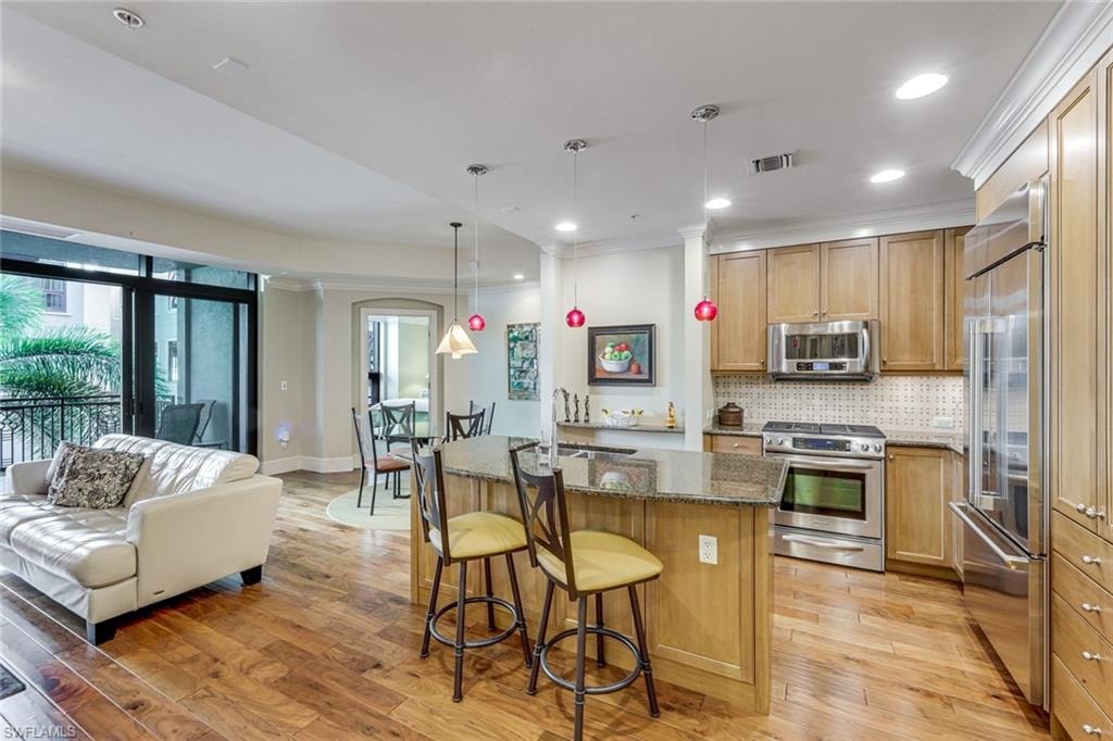 Open-concept kitchen and living area featuring wood-finish flooring