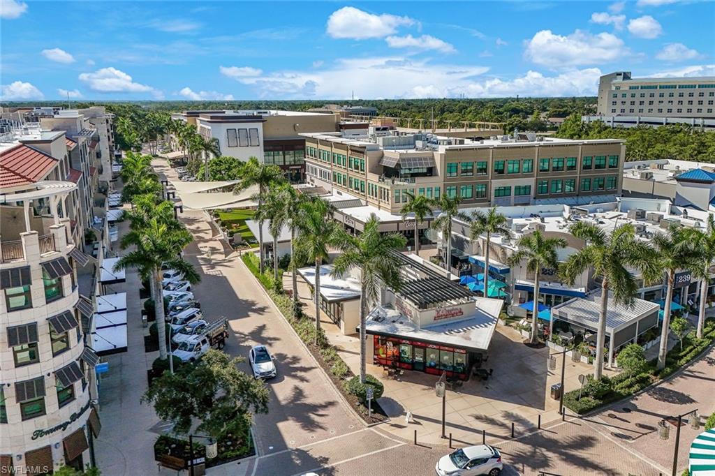 Aerial perspective of a mixed-use commercial and residential district featuring multiple retail buildings, professional offices, and integrated street-level dining establishments