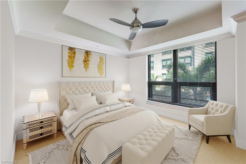 Tray ceiling featuring crown molding and a ceiling fan