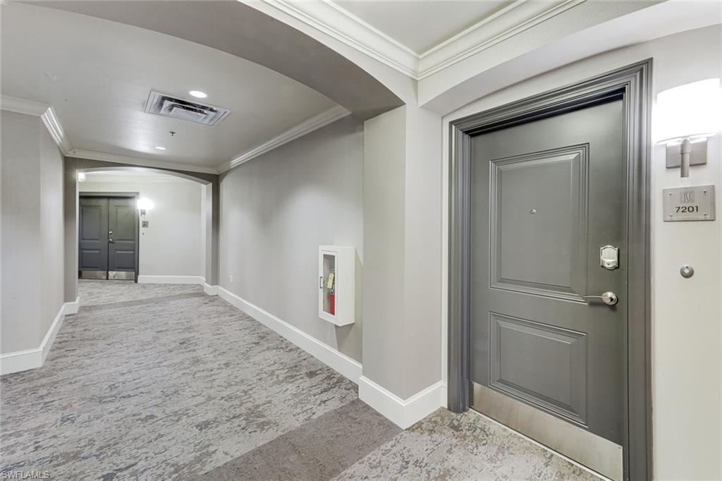 Large open hallways to large entry door right by the elevator
