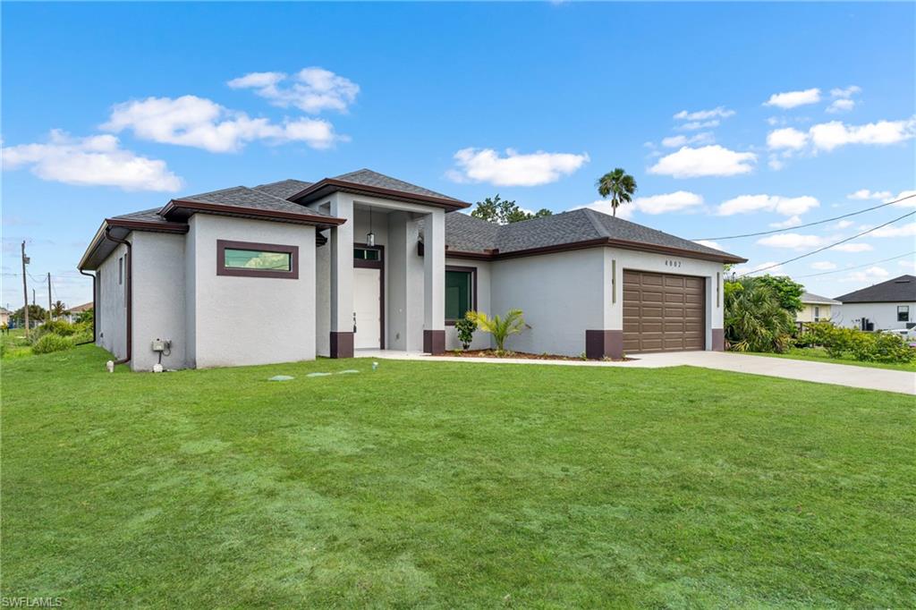 Contemporary stucco exterior with a dark shingle roof and a prominent covered entryway