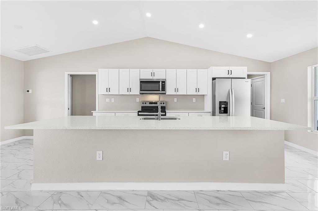 Expansive kitchen island featuring a light-toned countertop