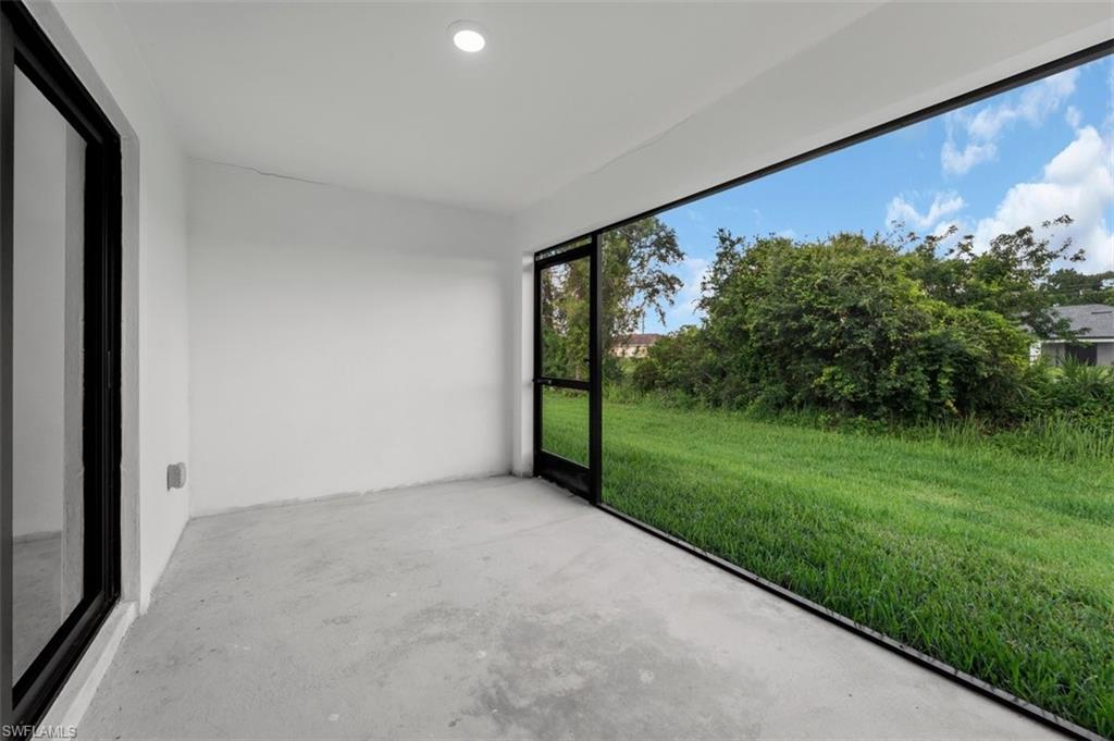 Screened patio featuring a concrete floor and white walls