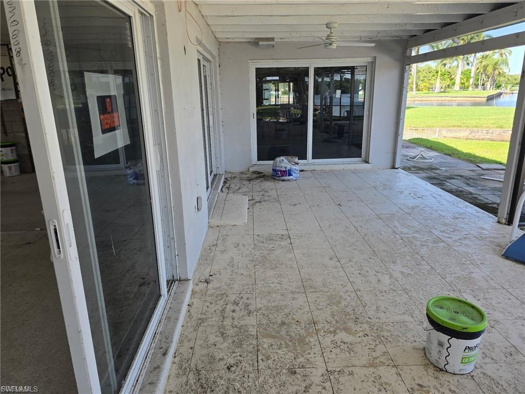 Expansive covered patio featuring large format tile flooring and multiple sliding glass doors