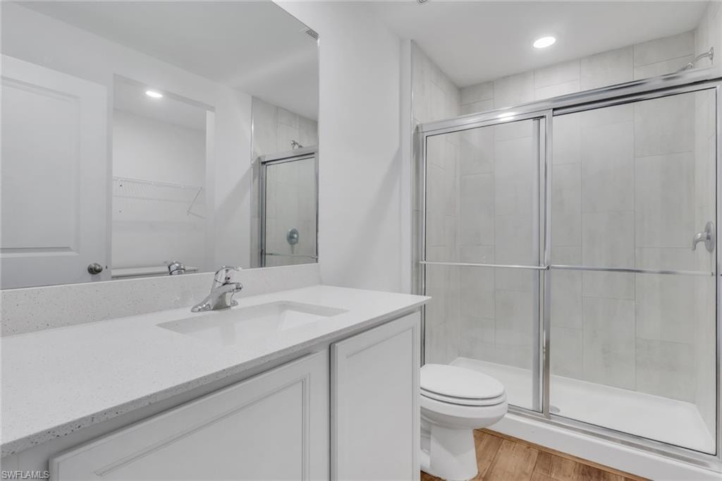 Primary bath with walk in shower and quartz counter tops and matching vanities.