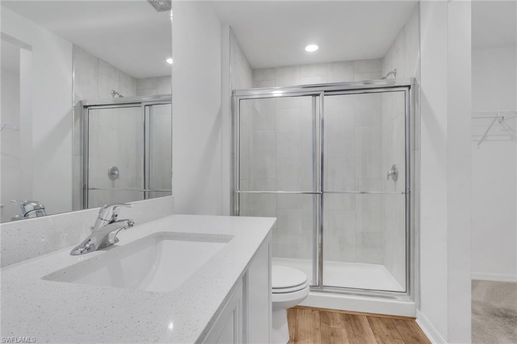 Primary bath with walk in shower and quartz counter tops and matching vanities.