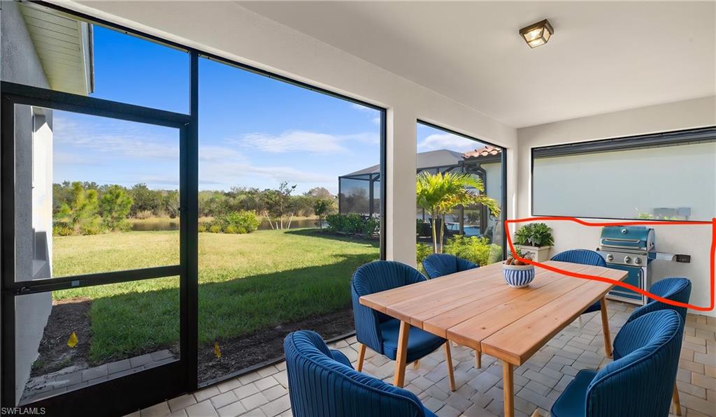 The expansive screened lanai overlooks a tranquil preserve and water view while offering ample space for dining, entertaining, or simply enjoying the peaceful surroundings. The highlighted area includes a natural gas outdoor kitchen rough-in, dedicated refrigerator circuit, and infrastructure already in place for the future outdoor kitchen of your dreams