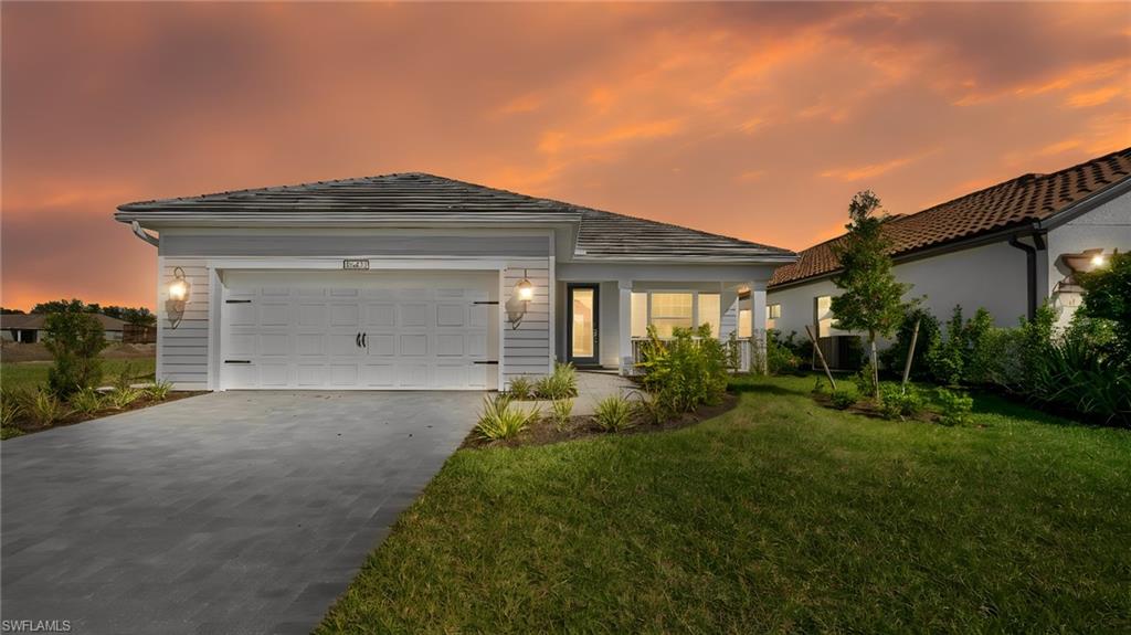 Bathed in the warm glow of a Florida sunset, this stunning Island-inspired residence showcases timeless architecture, elegant coach lighting, and exceptional curb appeal. From the upgraded elevation to the welcoming front porch, every detail reflects the quality and craftsmanship that make this home stand out within Verandah's premier golf and lifestyle community.
