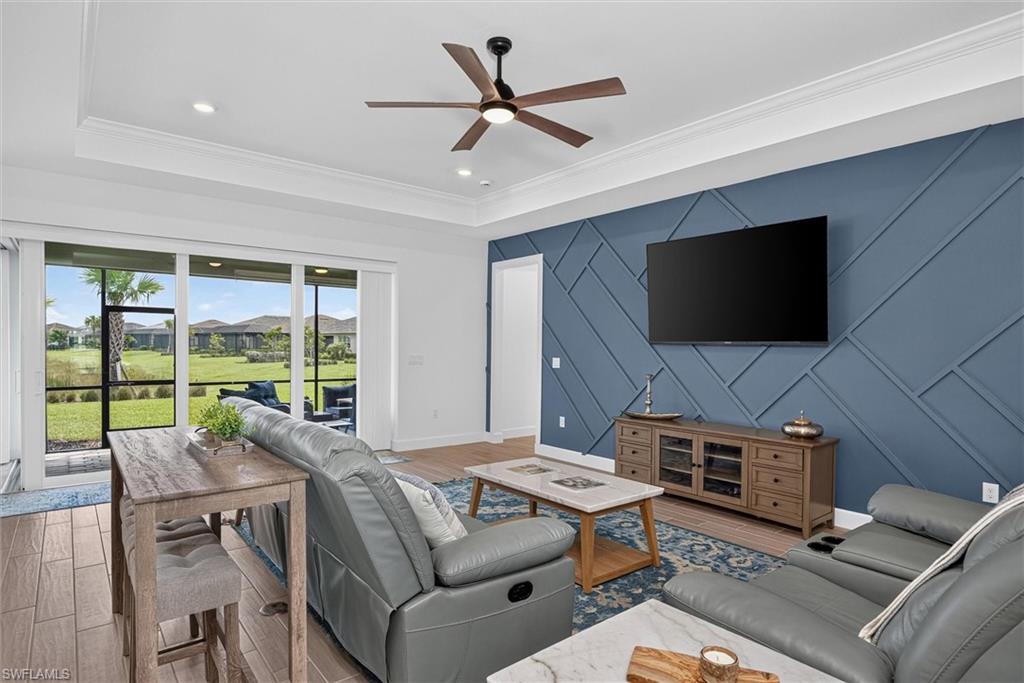 Stylish living space highlights by a custom designer accent walls and crown molding.