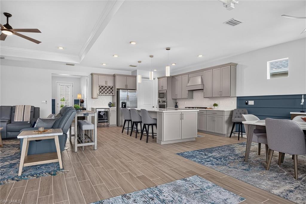 Grey cabinets with an accent wall in the dining area.  Notice the cabinets at the end of the island for extra storage