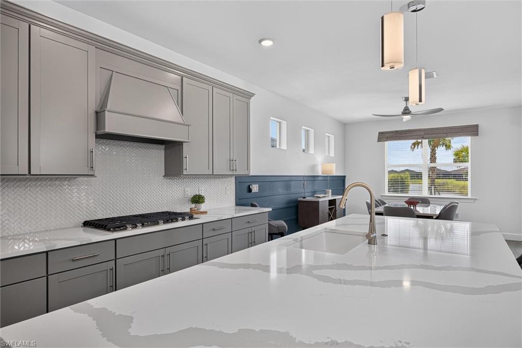 Oversized quartz counter with waterfall-inspired veining and abundant prep space
