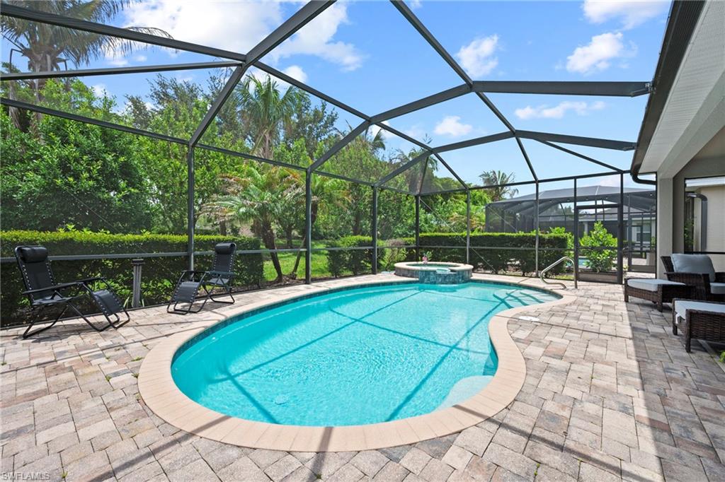 Screened lanai featuring lush perimeter landscaping